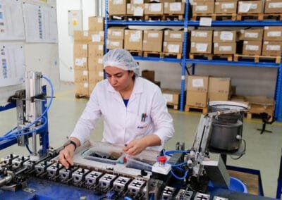 AXOPLAST operator inspecting injection-moulded parts on the assembly line